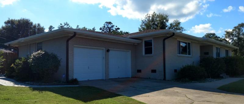 White aluminum gutters with bronze colord downspouts